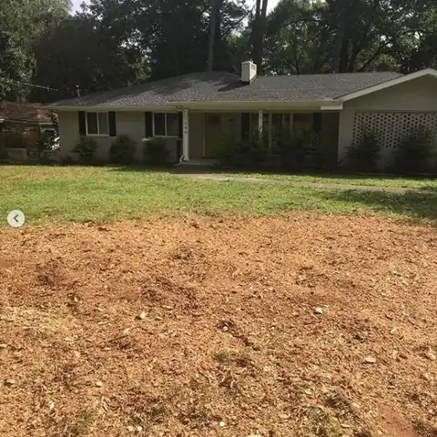 Ground area in front of a ranch house after the stump was ground out